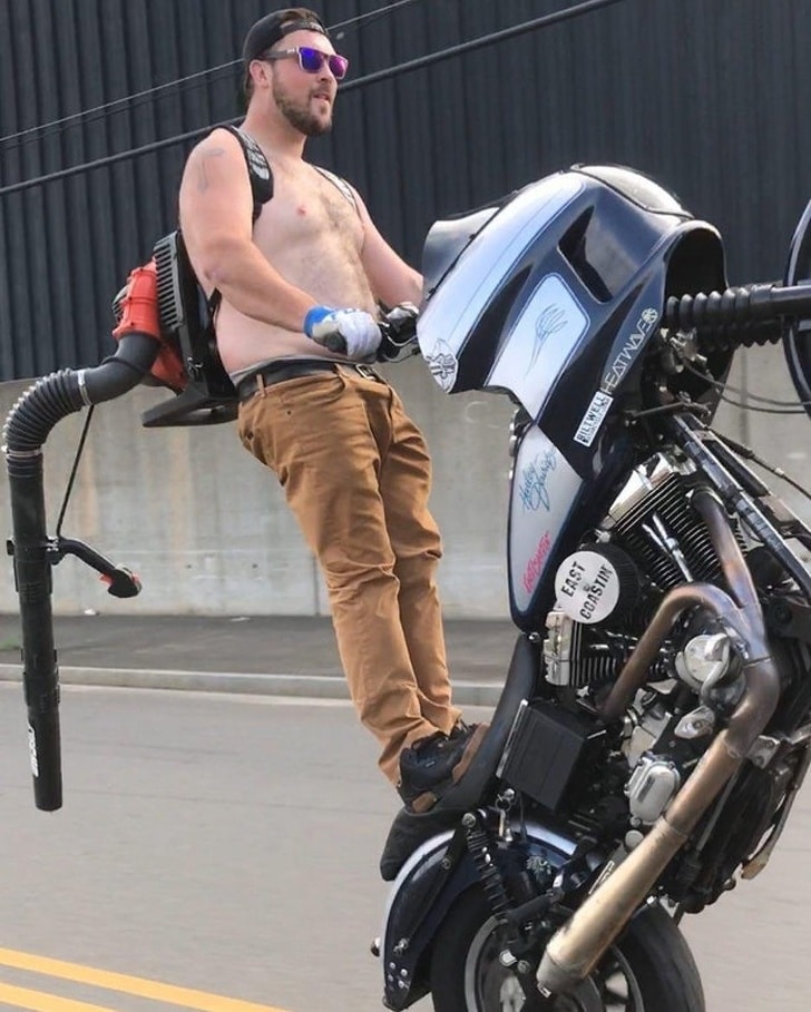 парень стоит на мотоцикле