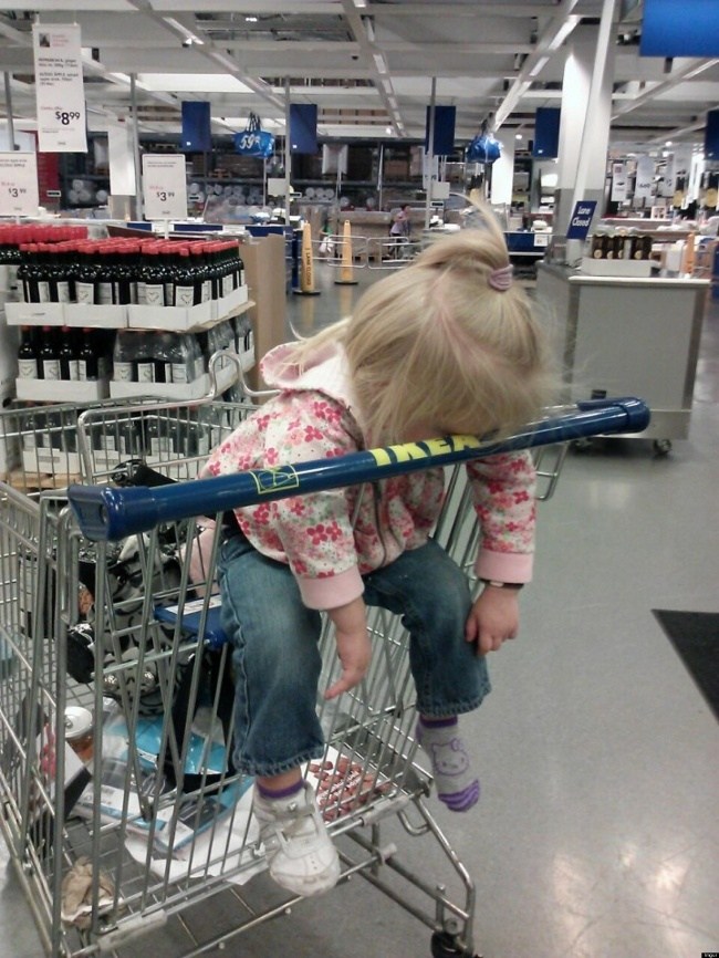 девочка спит в тележке в магазине