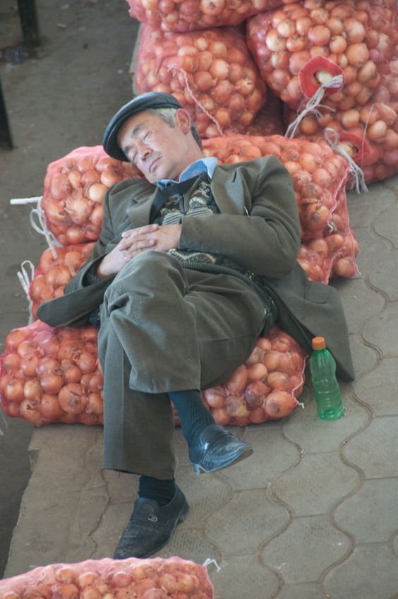 мужчина спит на мешке с луком