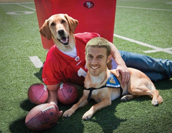 парень с собакой на футбольном поле