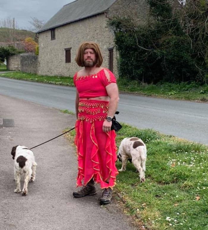 мужчина в красном платье с собаками